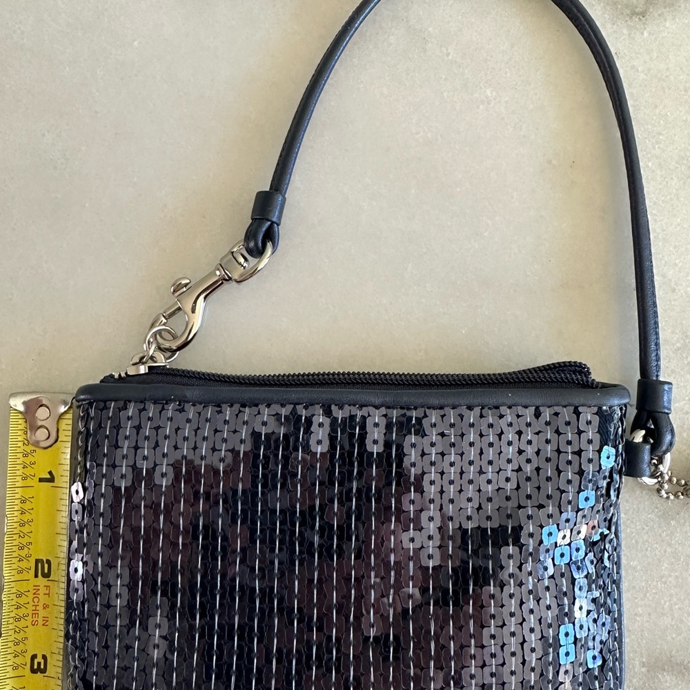 Used maybe a few times very clean navy blue shiny Coach wristlet